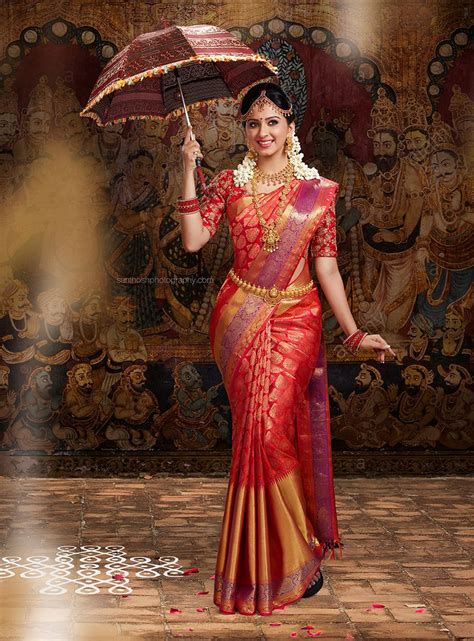 south indian bride wearing silk saree  holding  umbrella