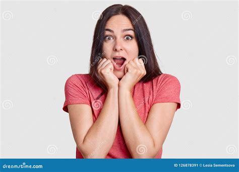 Shocked Beautiful Brunette Woman Keeps Mouth Widely Opened Holds Chin