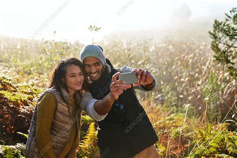 Couple Taking Selfie In Tall Grass Stock Image F032 2474 Science