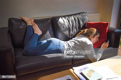 girl on couch with smart phone photo getty images