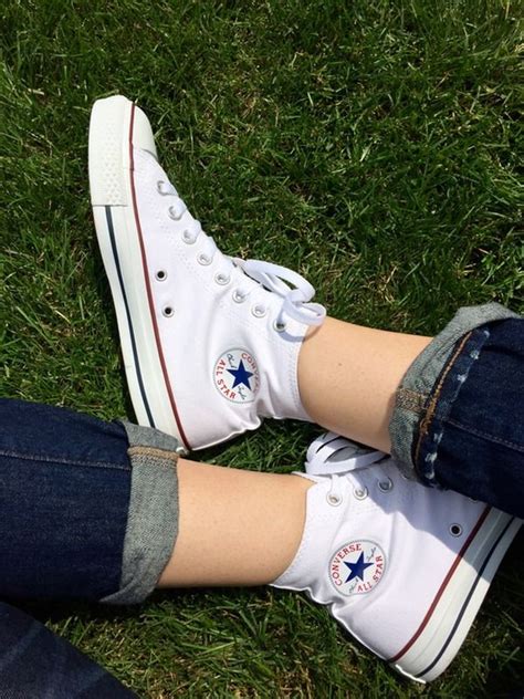 wearing white high top converse