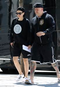 jessie j matches burly bodyguard in shorts and a baseball