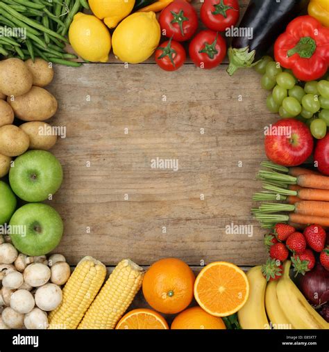 fresh fruits  vegetables forming  frame   wooden board
