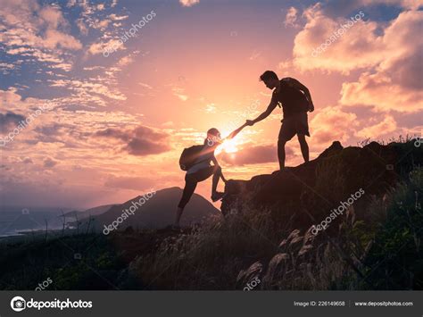 people helping   hike mountain sunrise stock photo image