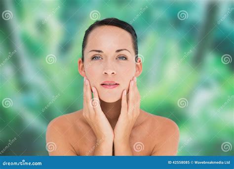 beautiful nude brunette posing with hands on face stock image image