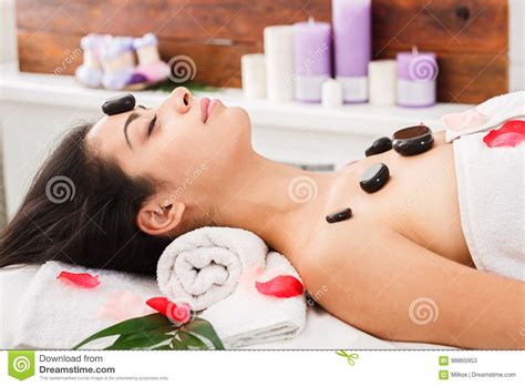 beautiful girl at stone massage spa in wellness center