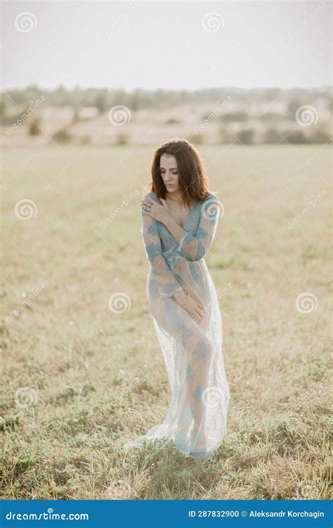 topless nude girl posing in field in summer added the effect of a