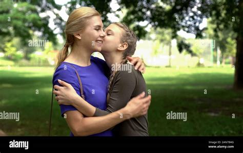 Pretty Girl Kissing And Hugging Her Beloved Mother Friendly