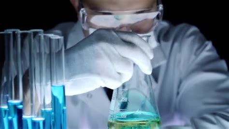 scientist mixing chemicals beaker chemist observation experiment stock video  elesaro