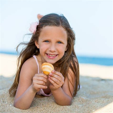 sweet girl holding seashell on beach stock image image of healthy