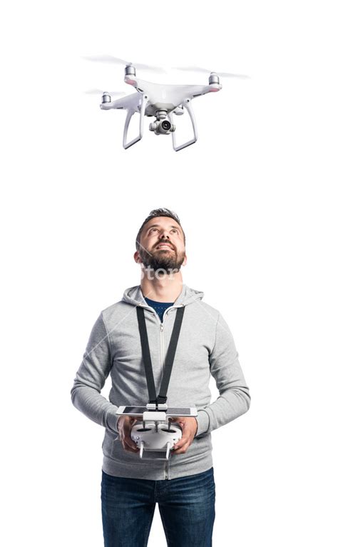 man  remote control  flying drone  camera studio shot  white background isolated