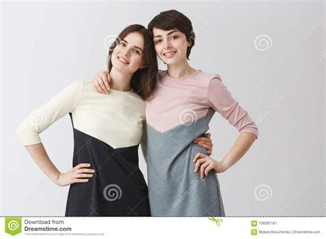close up portrait of joyful lesbian couple hugging each other holding