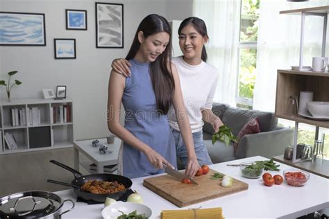 romantic asian lesbian couple is cooking on kitchen lgbt lesbian