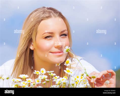 Young Beautiful Girl Laying On The Daisy Flowers Field Outdoor