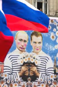 russian gay rights activists fly national flag next to poster with a