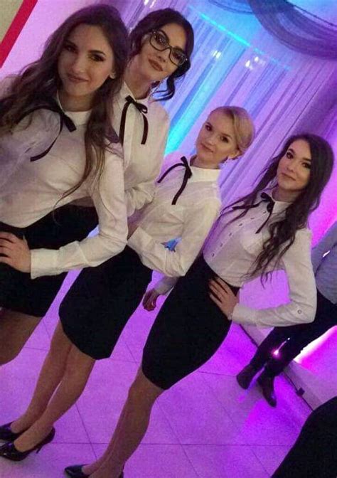 girls dressed  formal uniforms  white shirts  black bows