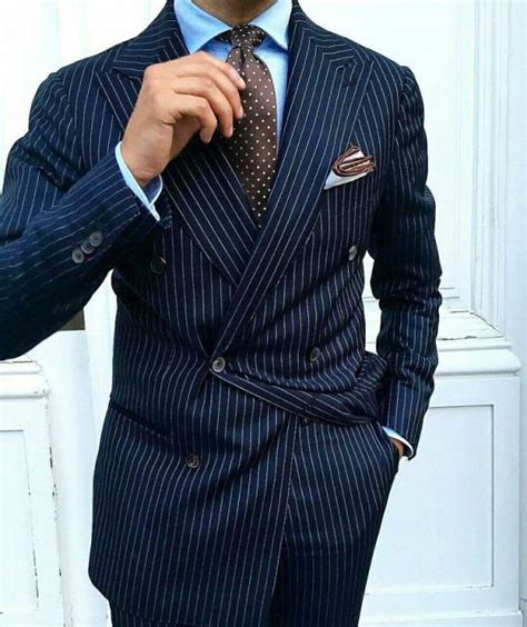 gentleman style navy pinstripe double breasted suit  brown tie  brown trim pocket