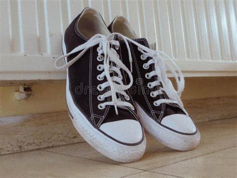 pair  tennis shoes  trainers black  white photograph