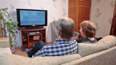 two mature people watching lcd tv with no signal screen with noise stock footage video 8595910