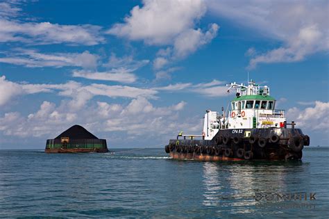 tug boat towing barge loaded  coal  east kalimantan indonesia photography  video
