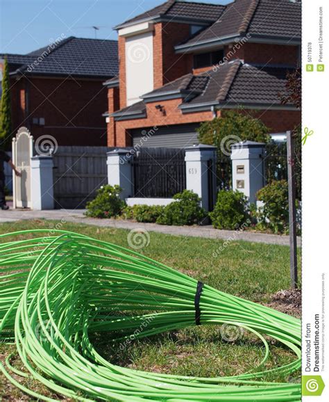 green fiber optic cable piled  front  residential housing editorial stock photo image