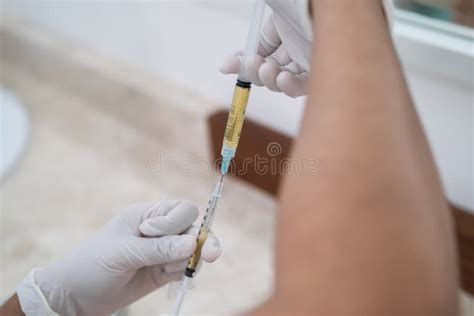 Close Up Of Nurse Or Doctor Hands Preparing Plasma Syringe For Prp