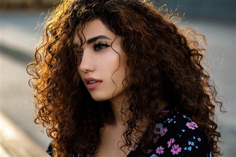 women model brunette curly hair face looking away
