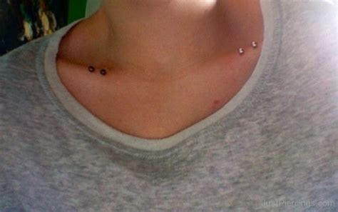 Collarbone Piercings With Black And Silver Barbells