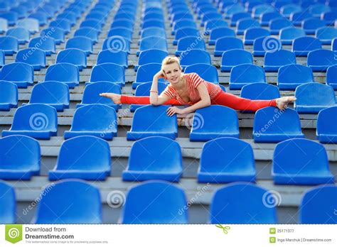 Sporty Woman Doing The Splits On Stadium S Seats Stock