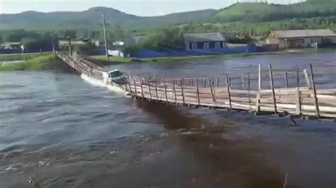 Russia Truck Driver Takes On Flooded Suspension Bridge And Loses