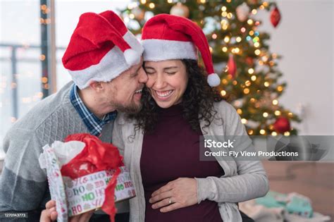 A Husband Give His Wife A Kiss On The Cheek On Christmas Day Stock