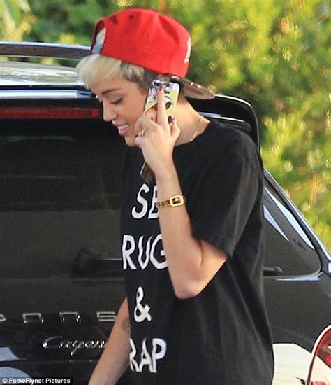 miley cyrus teams her sex drugs and rap t shirt with a pair of barely there shorts daily