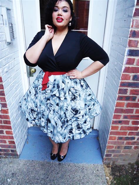 black wrap top red accent belt with black and white floral skirt