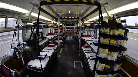 old school buses converted to ambulances evacuate nursing homes