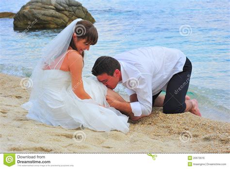 loving groom kissing with passion his bride s leg royalty