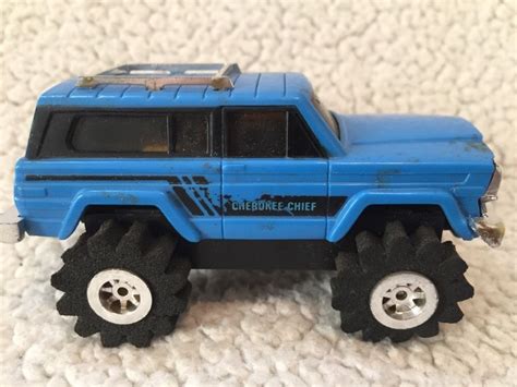 blue toy truck  black wheels   white surface