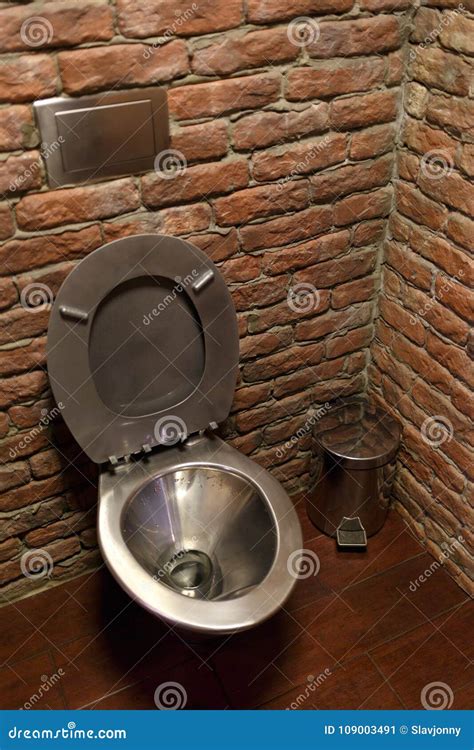 stainless steel toilet bowl  brick wall background stock image