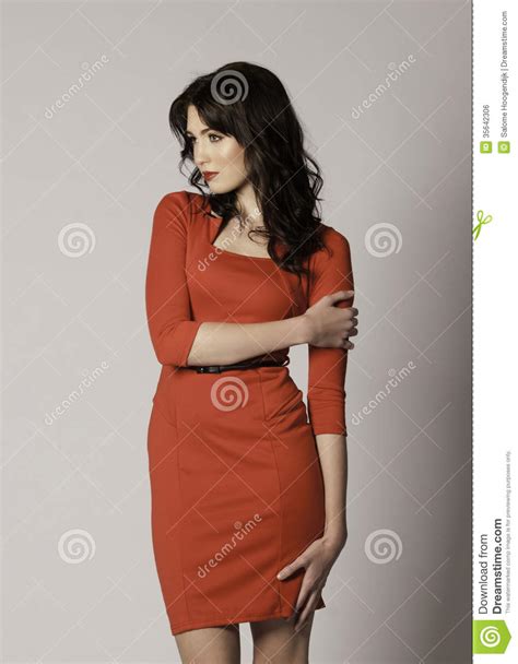 Beautiful Brunette Woman With Red Lips And Red Sexy Dress