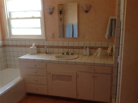bathroom vanity  tile  pedestal sink  wainscoting