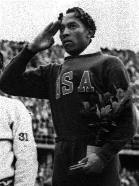 jesse owens of the u s salutes during the 1936 berlin germany olympic games he is holding an