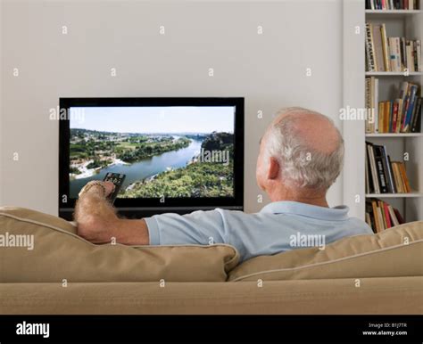 senior man watching tv stock photo  alamy