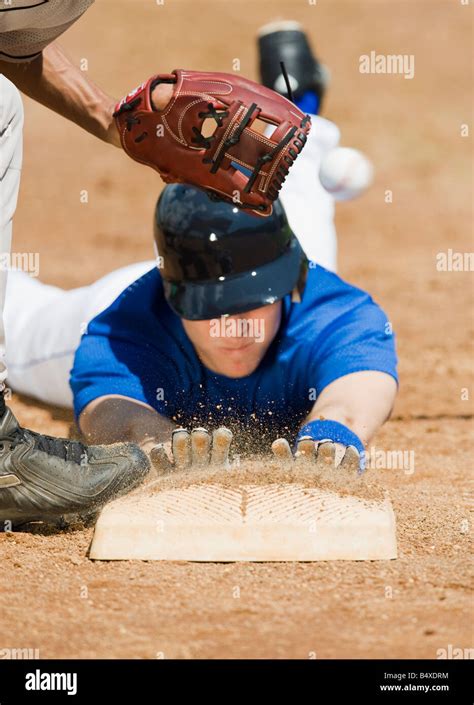 baseball player sliding  home base stock photo alamy