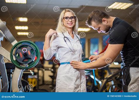 The Athlete In The Gym Measures With A Centimeter Tape The Waist Volume