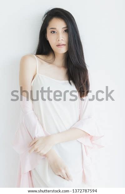 Sexy Asian Woman Model In Pajamas Standing And Posing In Seductive Mood