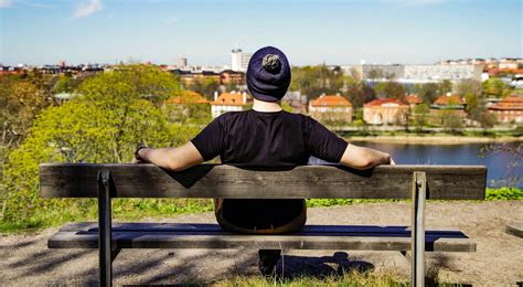 person sitting  brown bench  stock photo