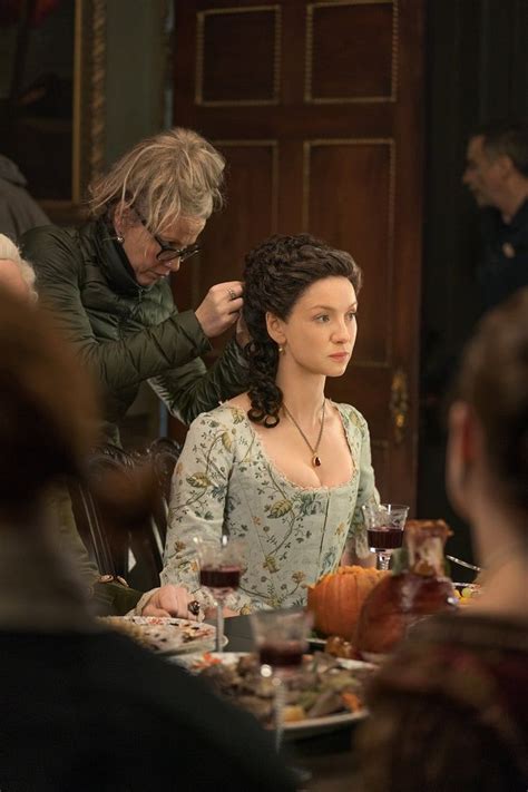 balfe gets her intricate updo styled in between takes during a season dramas de época