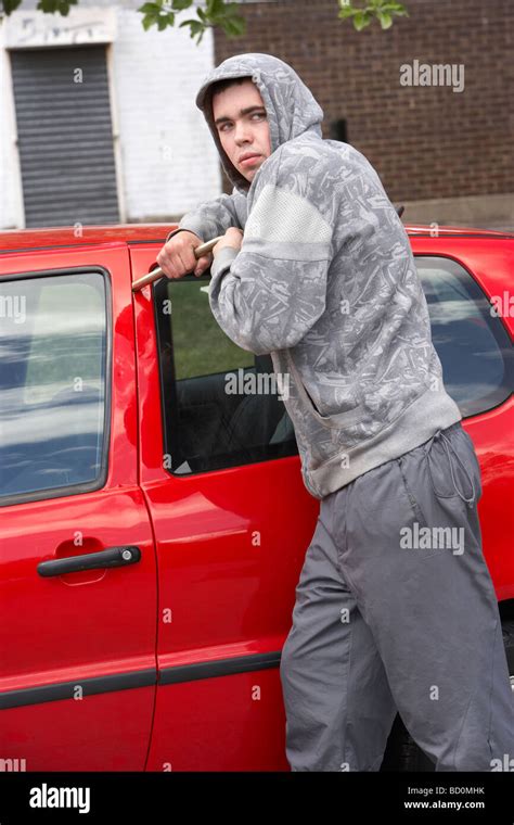 young man breaking  car stock photo alamy