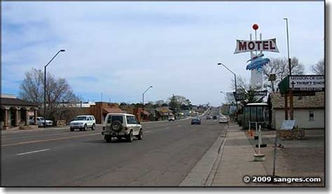 cars  driving   street  front  motels  motel signs  poles