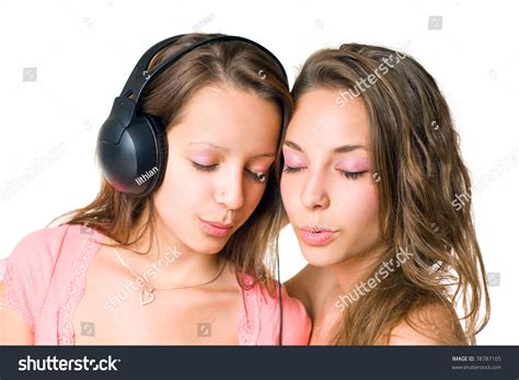 teen radio two gorgeous cute brunette teen girls having fun with headphones and music stock