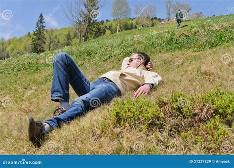man lying   steep hillside stock image image